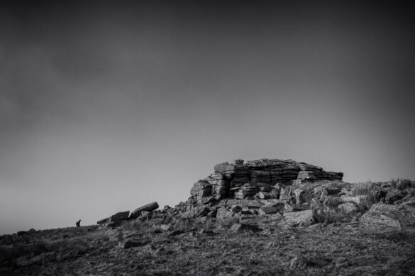A man hikes to great mis tor on Dartmoor